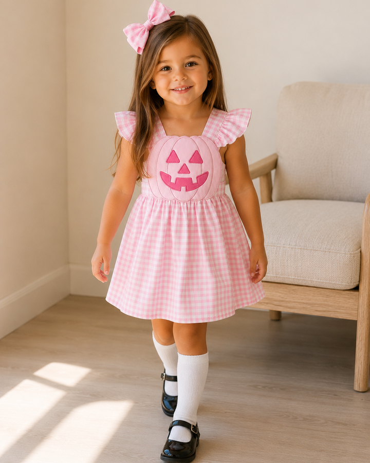 Pink gingham ruffle dress with jack-o-lantern face applique and flutter sleeves