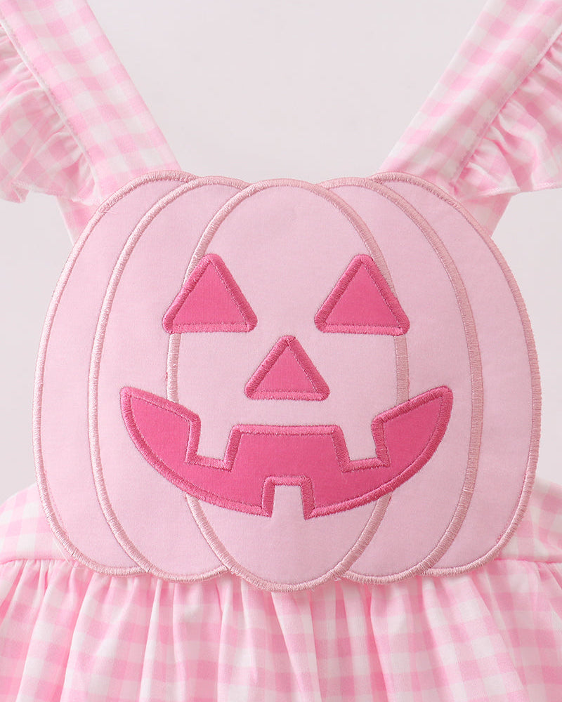 Pink gingham dress with jack-o-lantern face applique on the bodice
