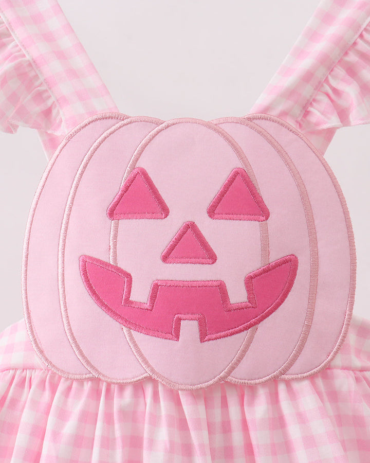 Pink gingham dress with jack-o-lantern face applique on the bodice
