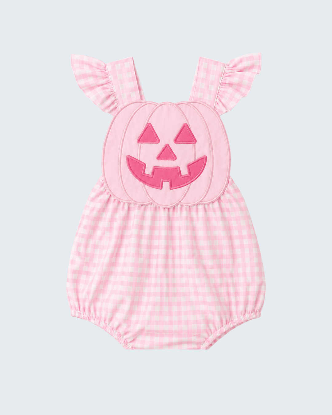 A pink and white gingham baby romper with a pumpkin face applique on the chest and ruffled shoulder straps, shown against a light gray background.