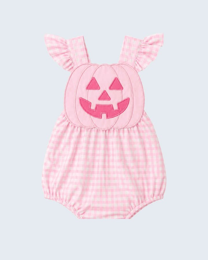 A pink and white gingham baby romper with a pumpkin face applique on the chest and ruffled shoulder straps, shown against a light gray background.