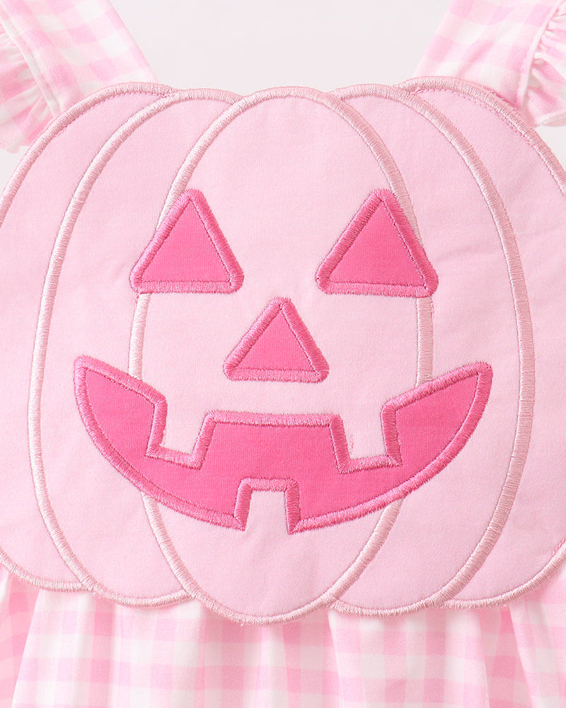 Jack-o-lantern face applique on pink gingham bubble romper, stitched outline detail