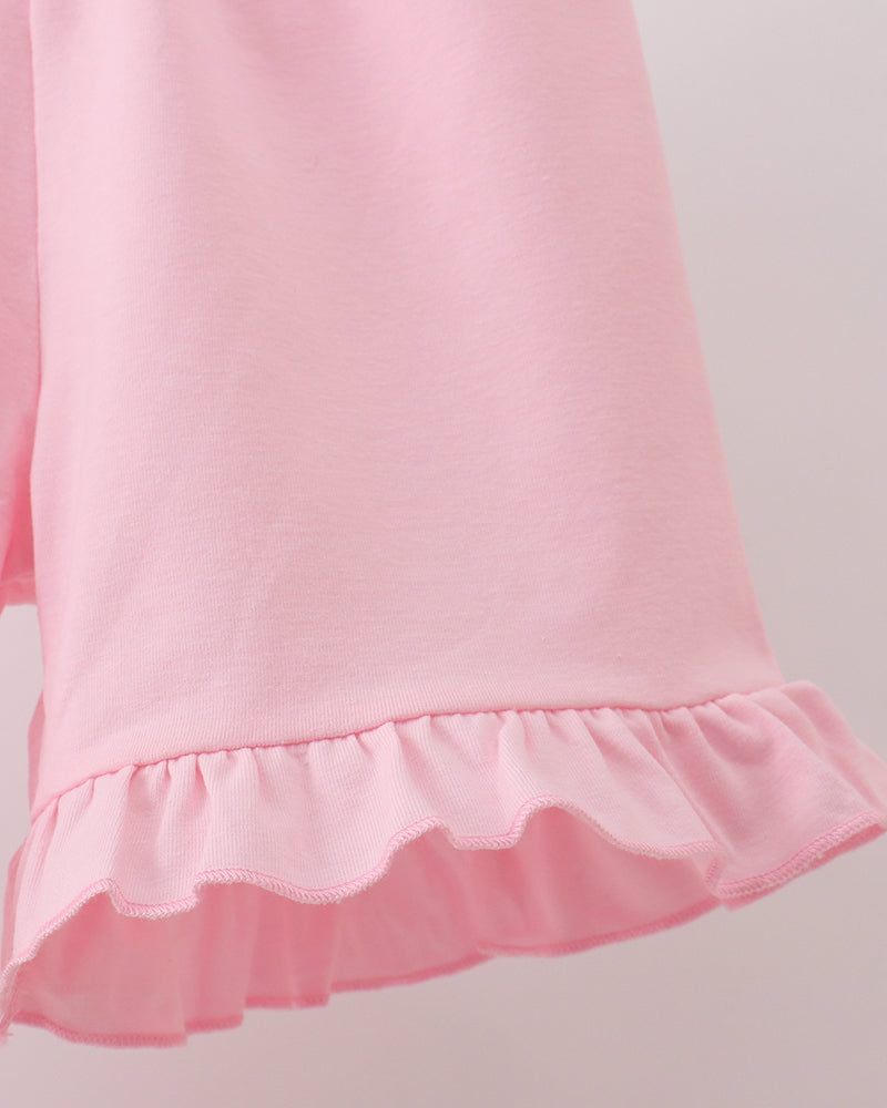 Pink shorts with scalloped ruffle hem detail
