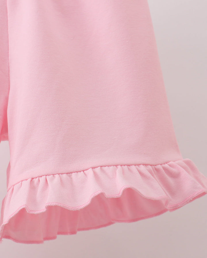 Pink shorts with scalloped ruffle hem detail