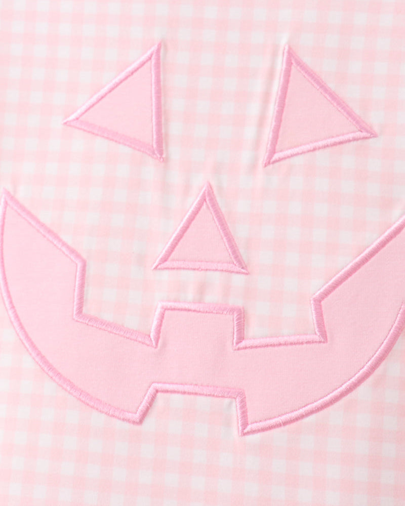 Pink jack-o-lantern applique embroidery on gingham fabric