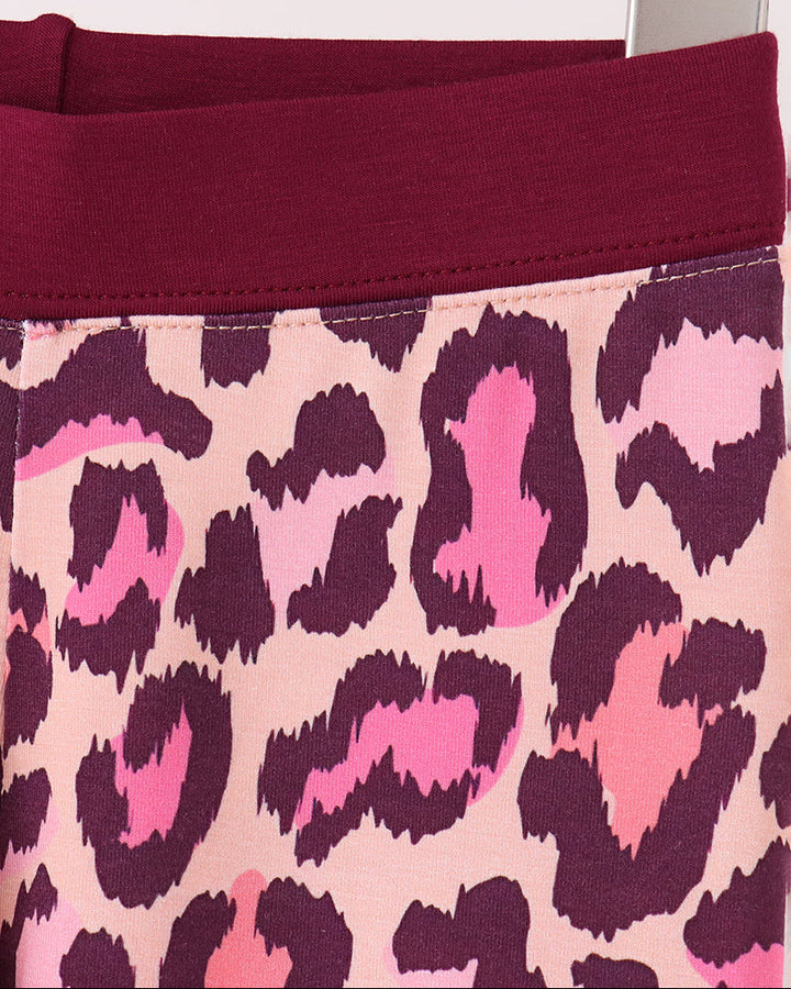 Pink leopard pajama pants with dark plum waistband and matching cuffs