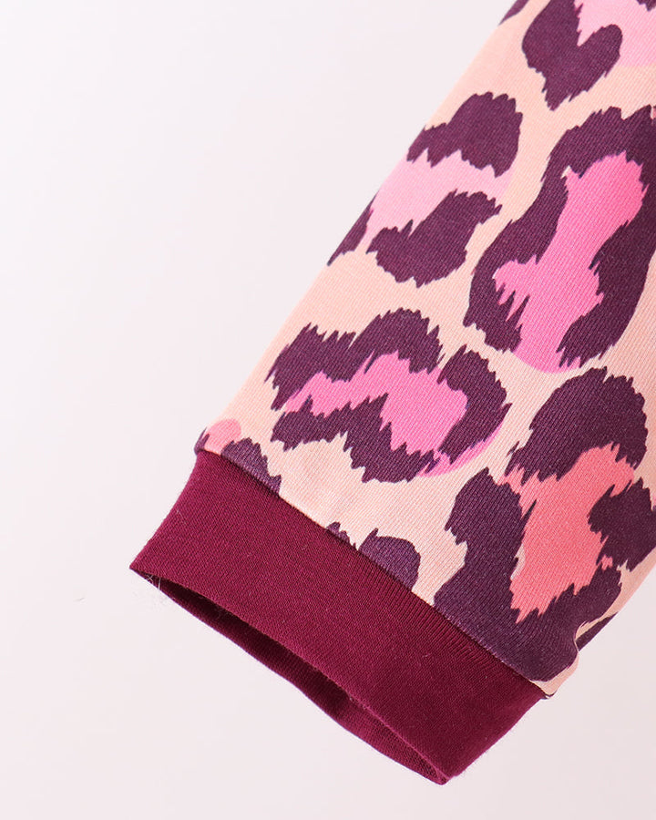 Pink leopard pajama sleeve with dark plum ribbed cuff