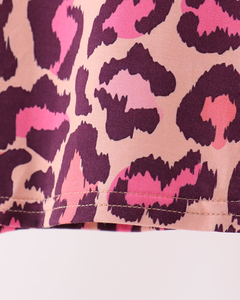 Pink leopard pajama top hem with stitched finish and dark plum trim