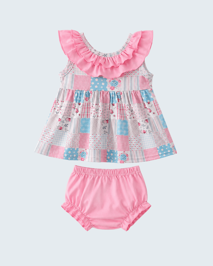 Baby dress with ruffled neckline and matching bloomers on a light gray background