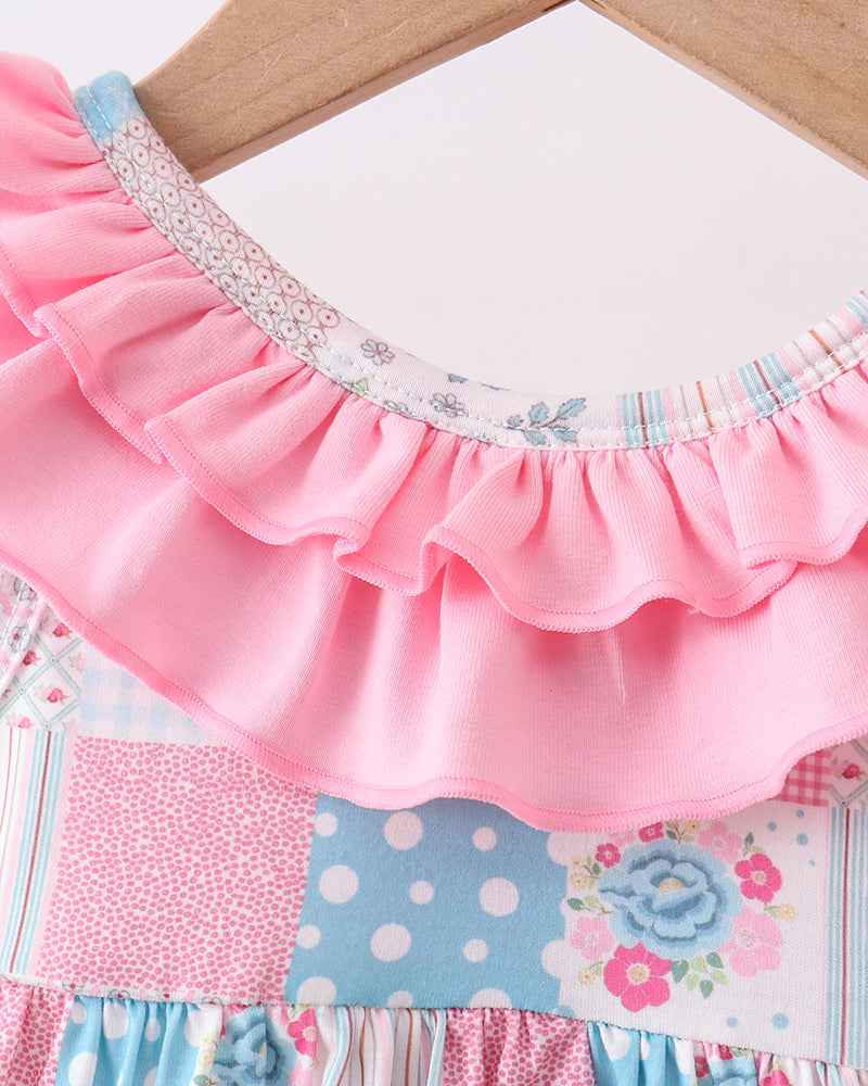 Patchwork skirt with pink ruffled edge on a wooden surface