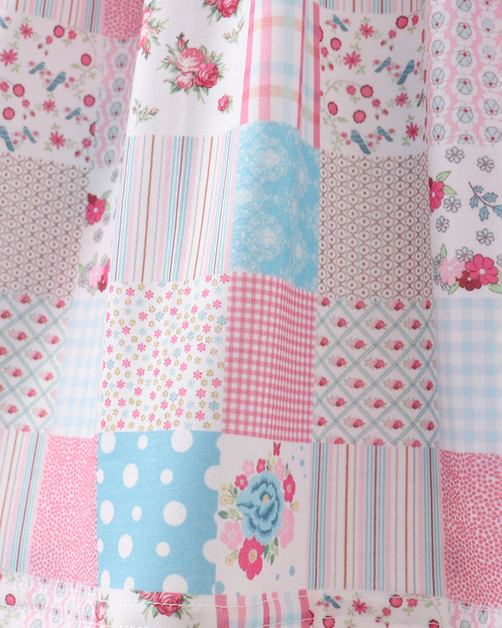 Patchwork dress with various patterns and colors on a white background