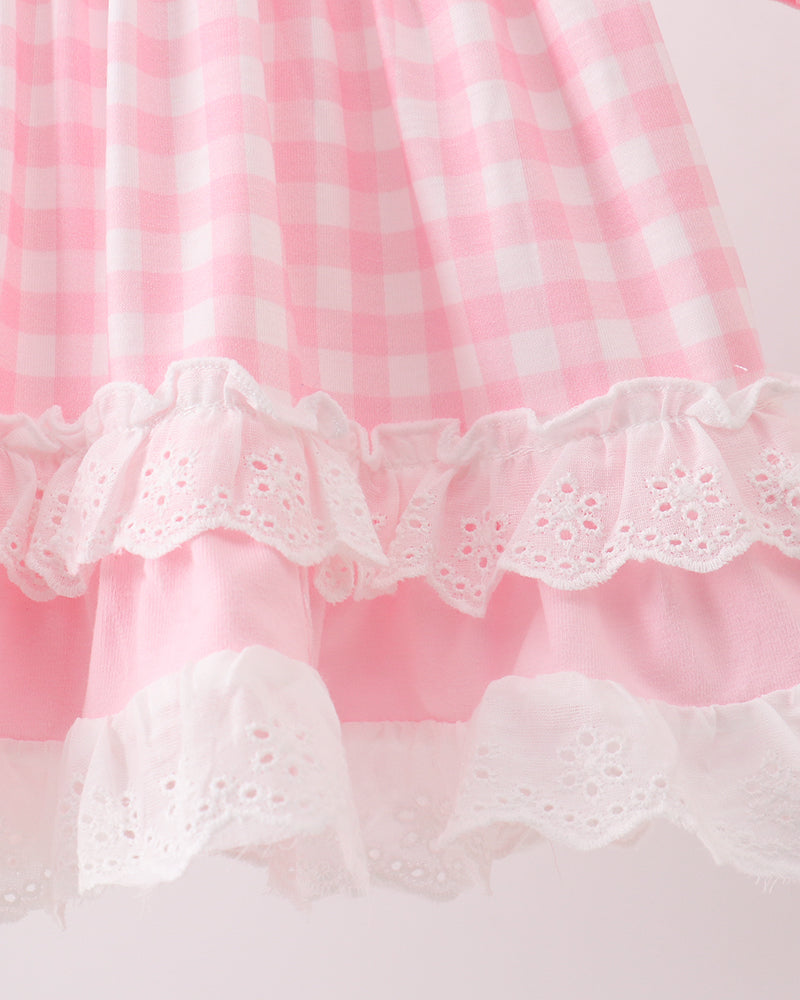 Pink-and-white ruffled top hem with lace trim and layered skirt detail