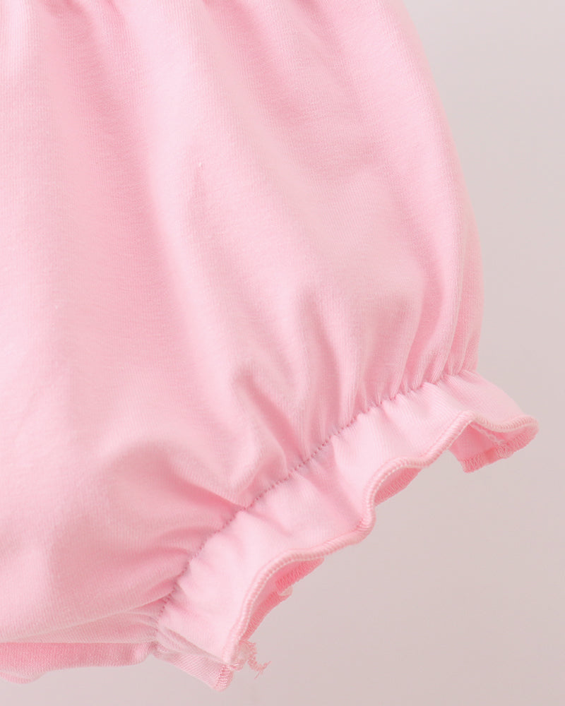 Pink bloomer shorts with ruched waist and double-layer ruffle at leg hem
