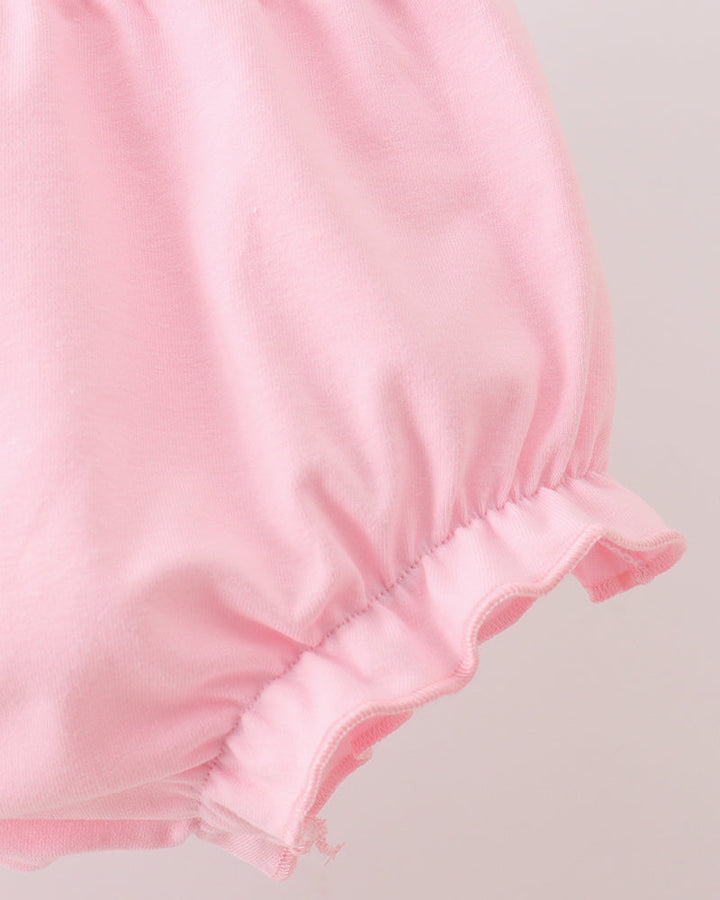 Pink bloomer shorts with ruched waist and double-layer ruffle at leg hem