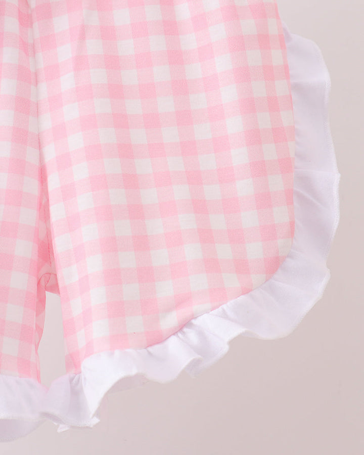 Pink gingham ruffle shorts with white ruffled hem and elastic waistband
