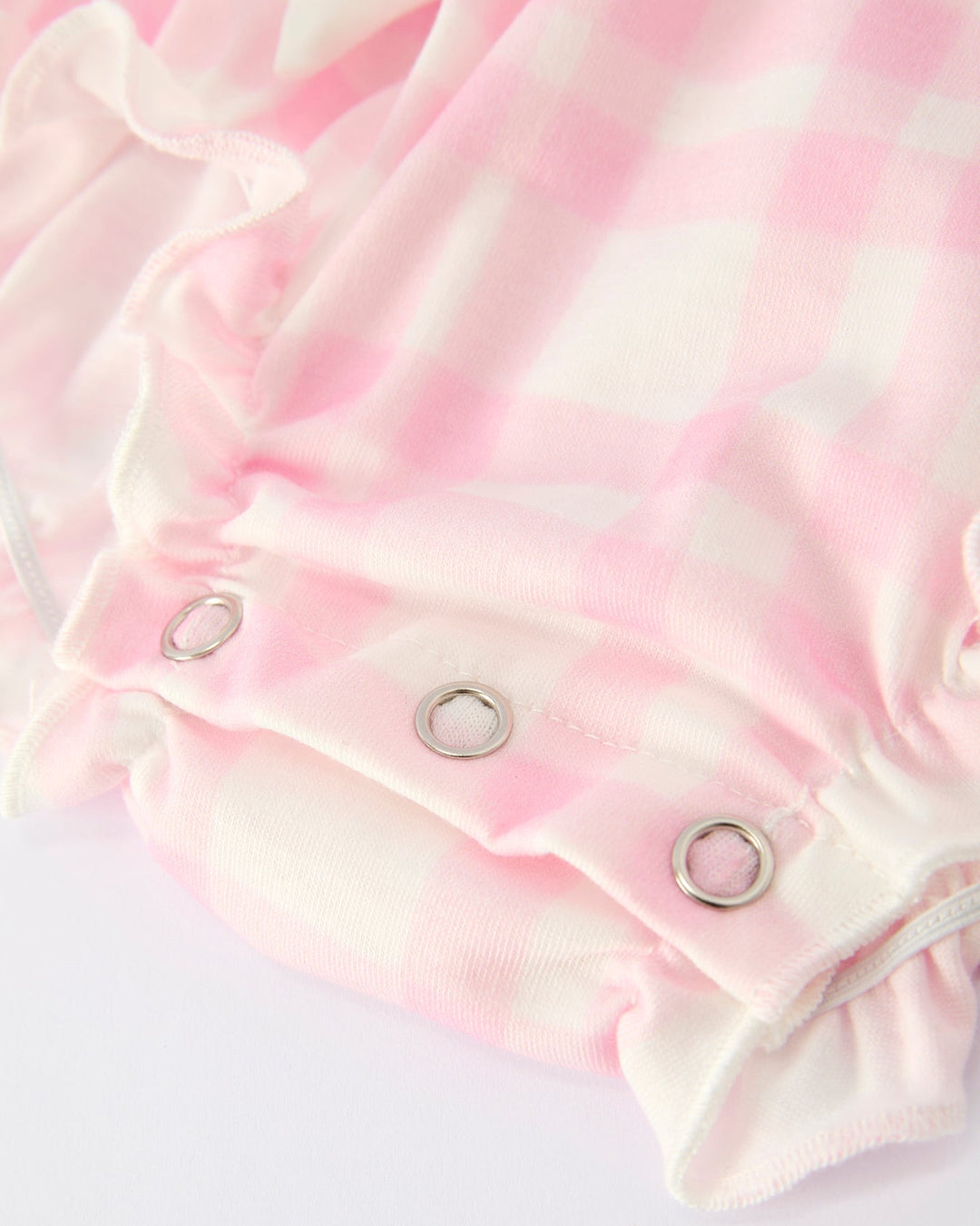 Pink plaid romper with snap-button closure and ruffled leg openings