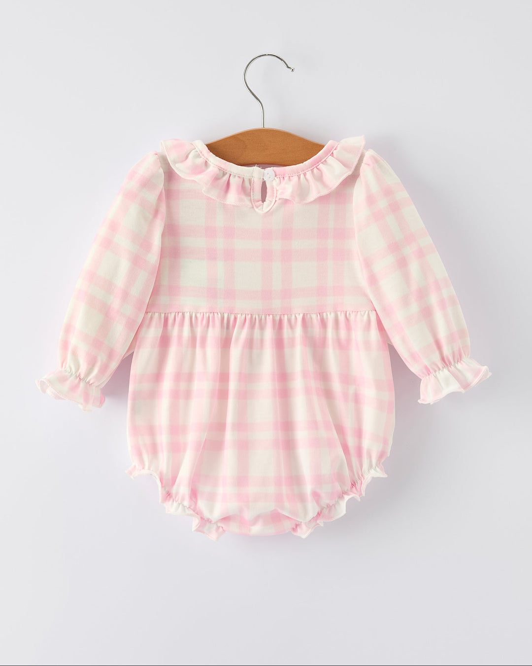 Pink plaid long-sleeve romper with gathered waist, frilly cuffs, and bubble hem