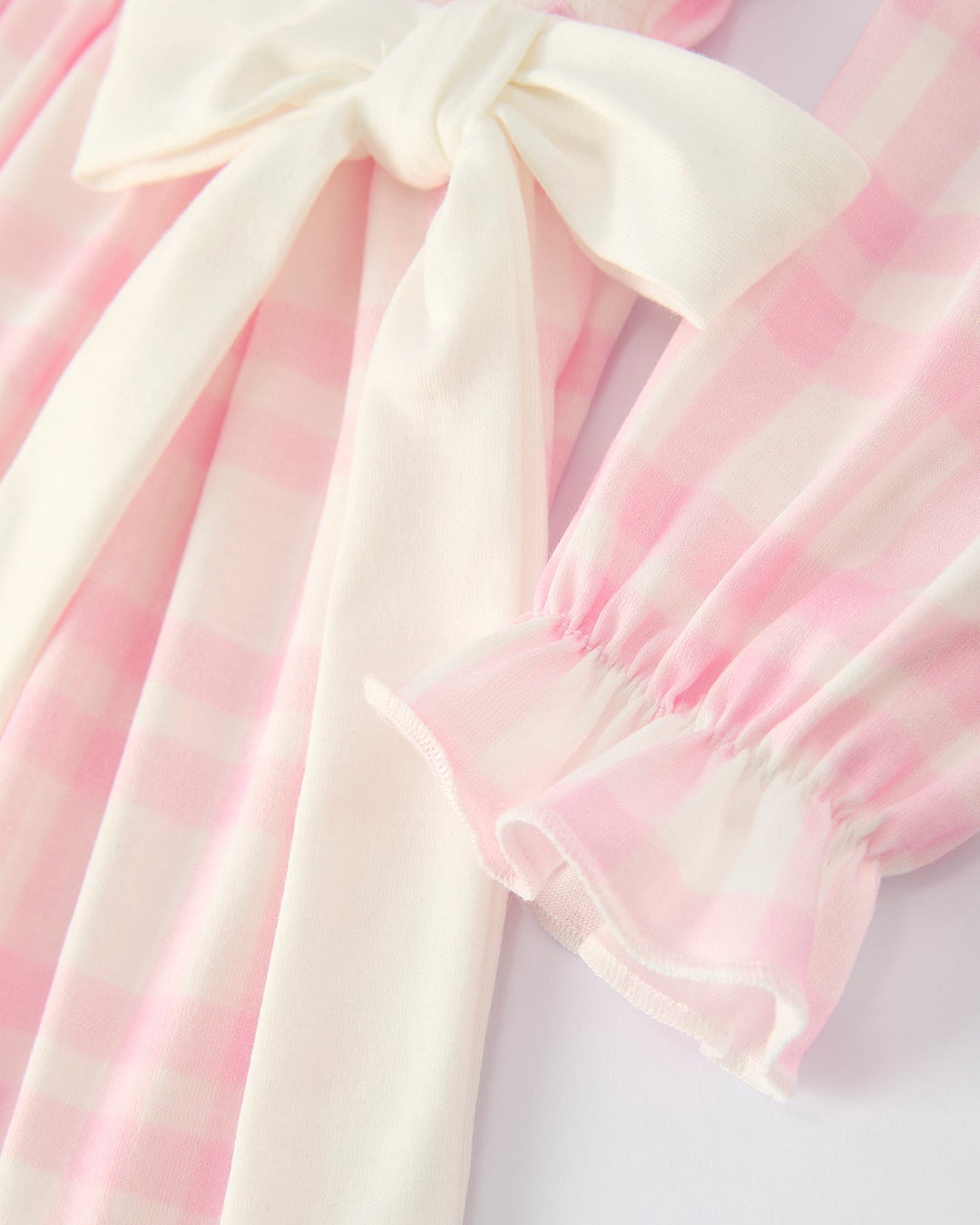 Pink plaid dress with long tie-back bow and ruffled sleeve cuffs