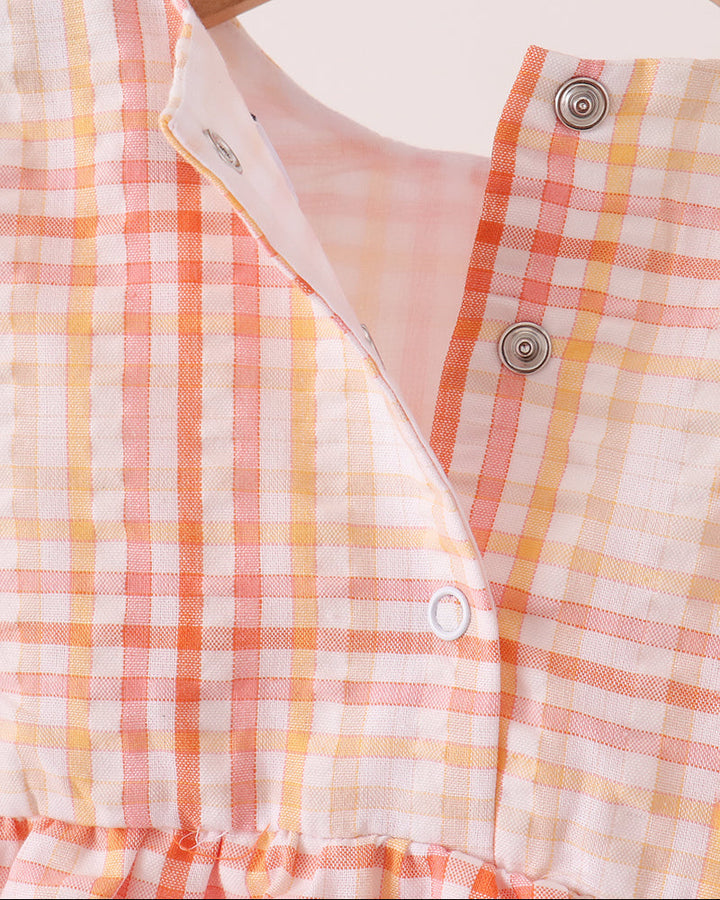 Plaid bubble romper neckline with V-slit and button placket with snap closures