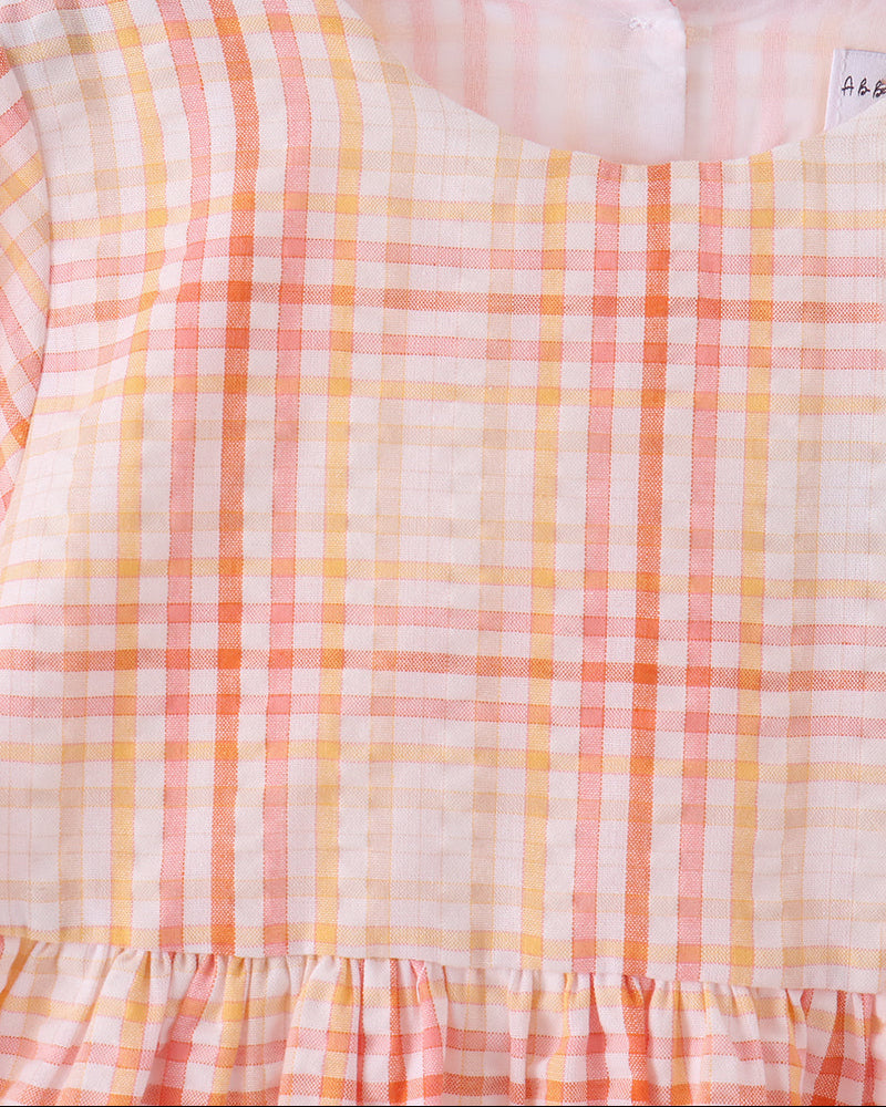 Pink-and-orange plaid dress back with gathered waist ruffle and long sleeves