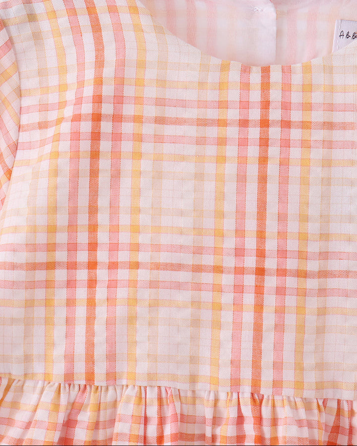 Pink-and-orange plaid dress back with gathered waist ruffle and long sleeves