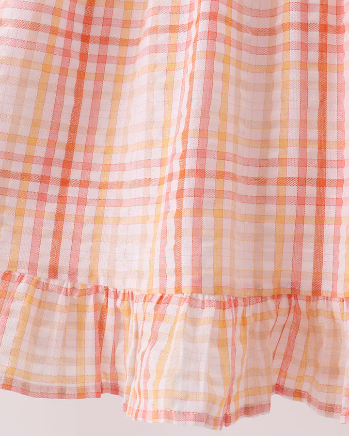 Pink-and-orange plaid dress with tiered ruffle hem and gathered skirt