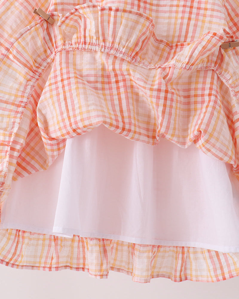 Pink-and-orange plaid dress bodice with shoulder ruffles and tiered skirt