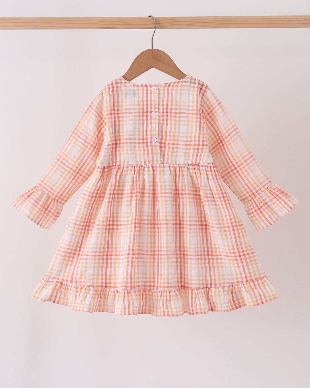 Pink-and-orange plaid long-sleeve dress with button placket and tiered ruffle skirt