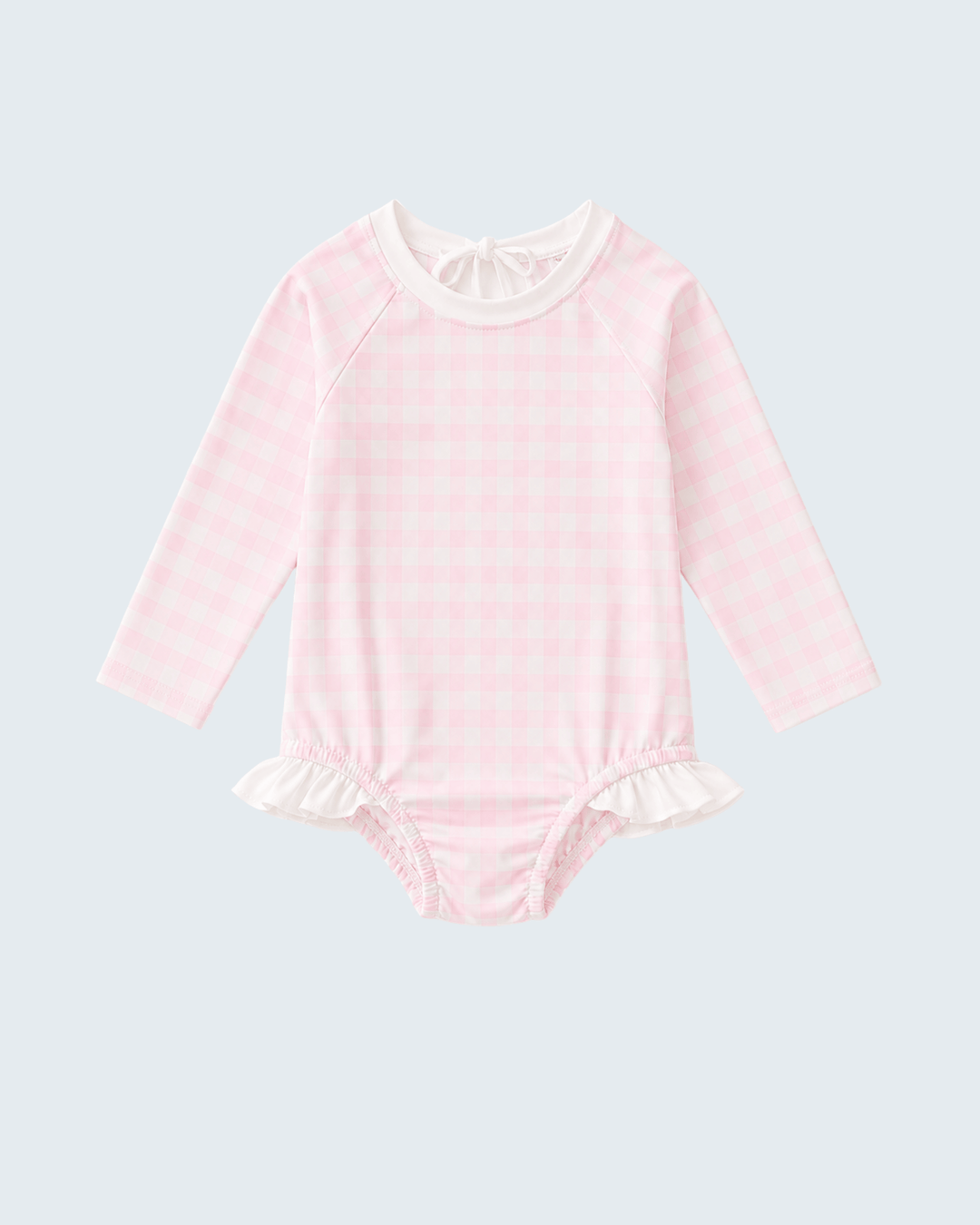 Pink rashguard with ruffled details on a light gray background