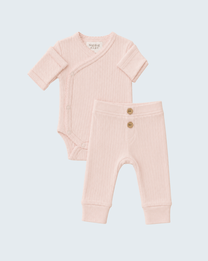 Pink pointelle baby layette set with short-sleeve bodysuit and matching jogger pants