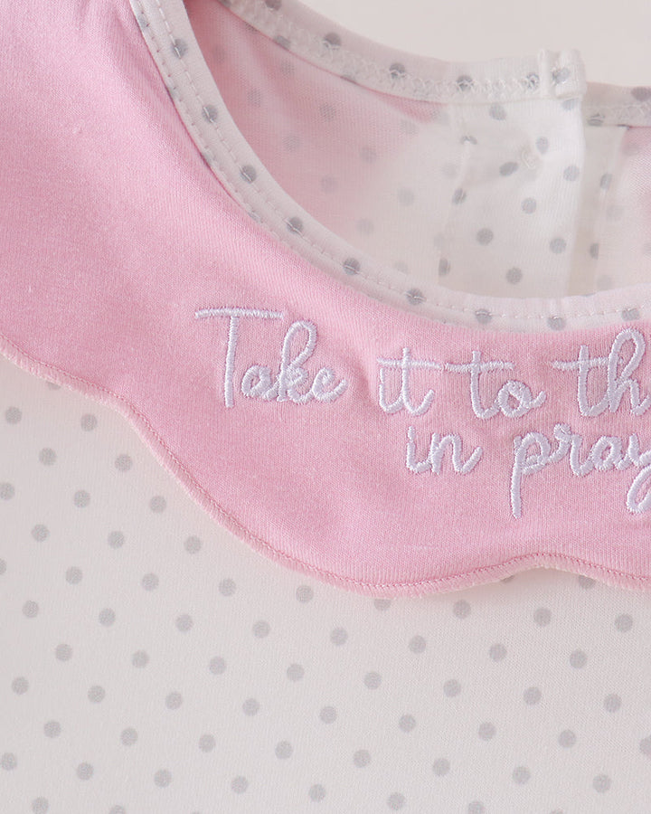Pink ruffled Peter Pan collar with embroidered script on white polka-dot dress