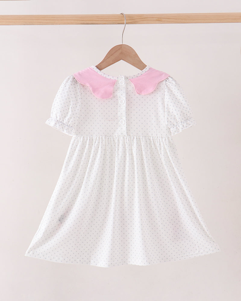 White polka-dot dress with pink Peter Pan collar and gathered skirt