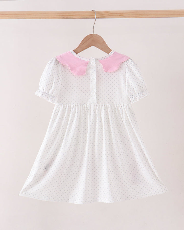 White polka-dot dress with pink Peter Pan collar and gathered skirt