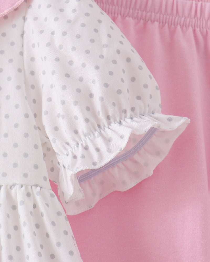 White polka-dot dress sleeve with pink ruffled cuff and gathered elastic hem