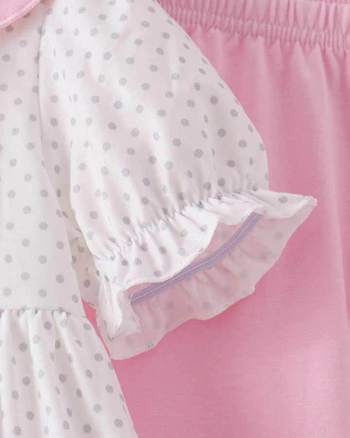 White polka-dot dress sleeve with pink ruffled cuff and gathered elastic hem
