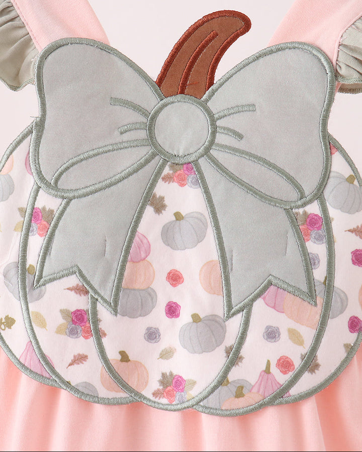 Pumpkin-print ruffle bubble with large bow and pumpkin applique