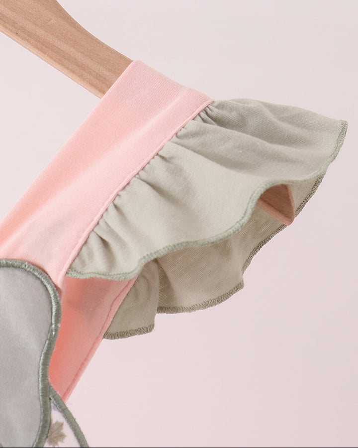Pink and green layered sleeve ruffle with stitched trim on a child dress