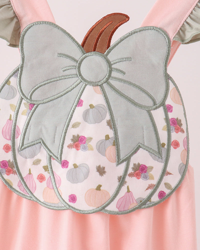 Pink pumpkin romper with large bow appliqué and floral print front panel