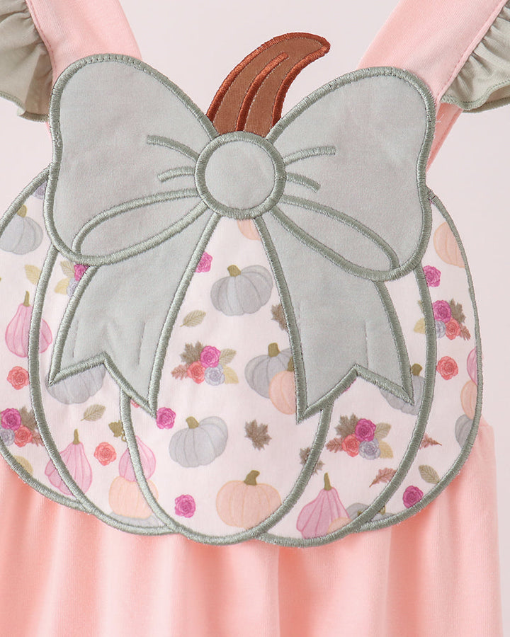 Pink pumpkin romper with large bow appliqué and floral print front panel