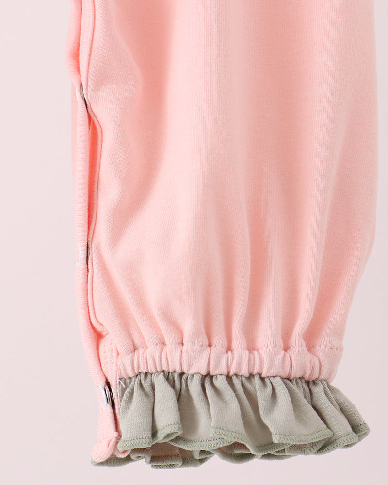 Pink romper with gathered ankle cuffs and olive-green ruffle hem