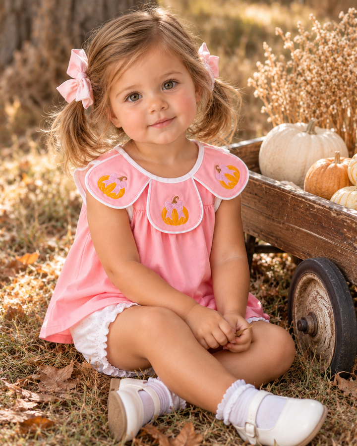 Toddler girl is wearing a Pink Pumpkin Embroidered Bloomer Set