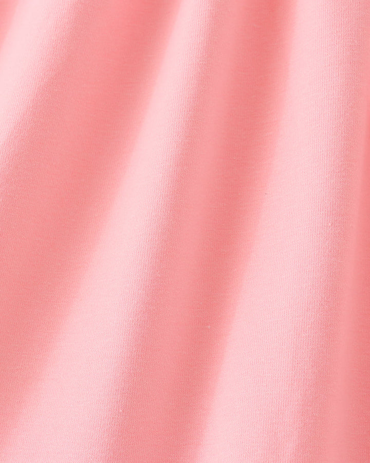 Pink sleeveless dress fabric close-up with subtle texture