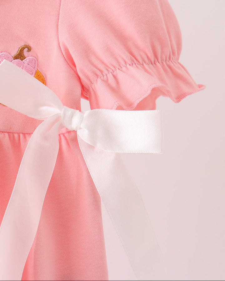 Pink baby bubble romper with bow sash and short puff sleeves