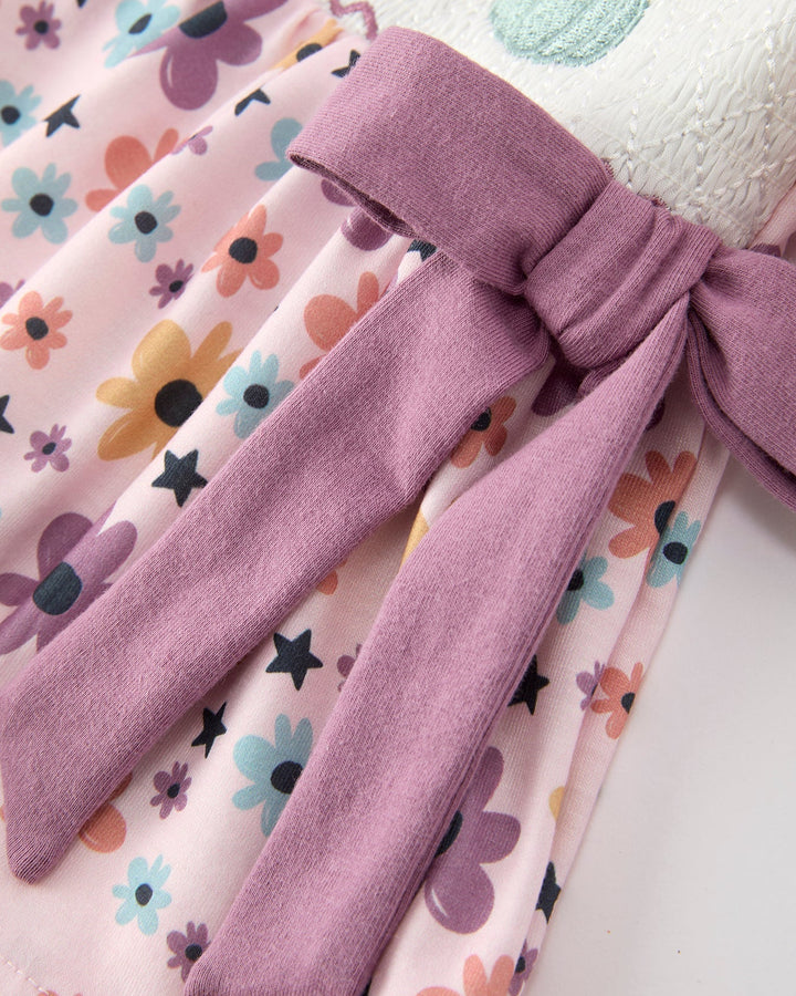 Lavender bow detail on pink floral dress top with gathered skirt and sleeves