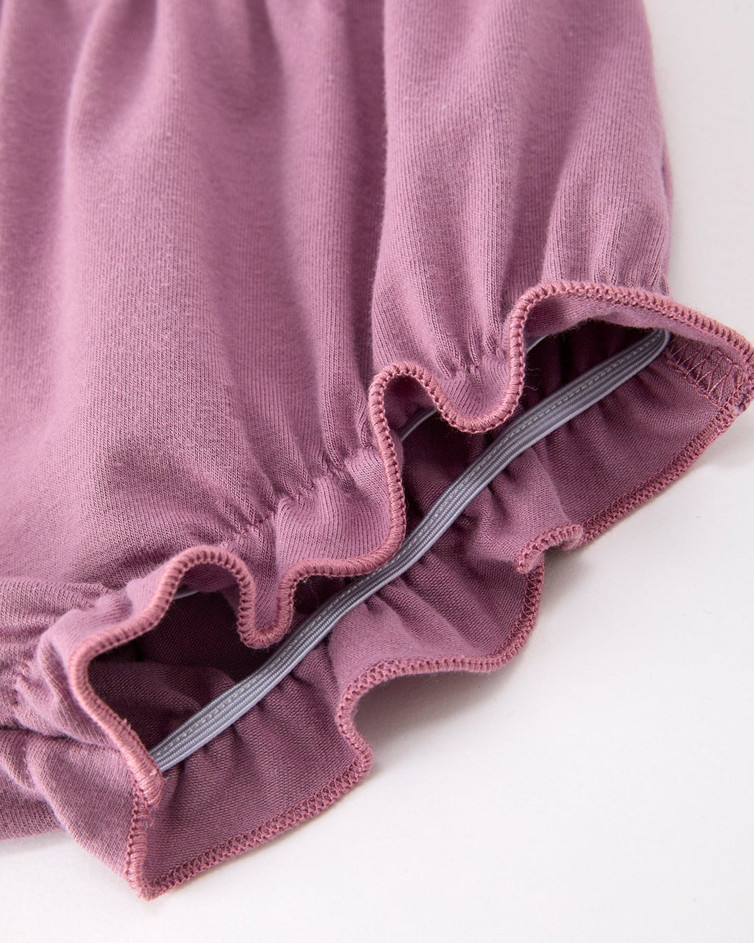 Close-up of lavender ruffle leg opening and elastic edge on baby bloomers