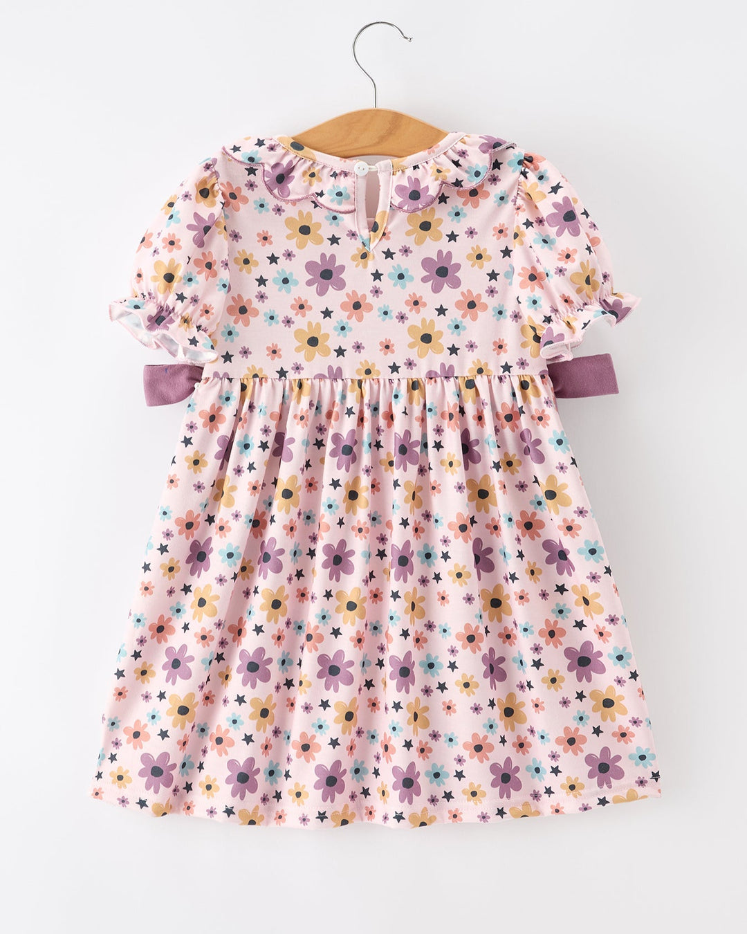 Girls light pink floral-and-star dress with short puff sleeves and lavender side bows