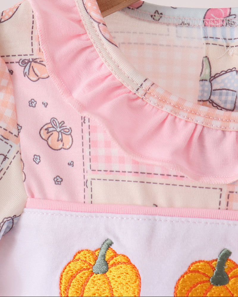 Pink baby bubble romper with ruffled neckline and pumpkin embroidery detail