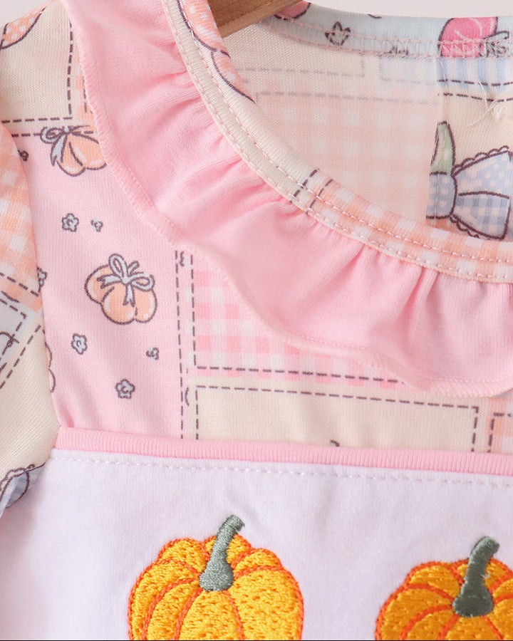 Pink baby bubble romper with ruffled neckline and pumpkin embroidery detail