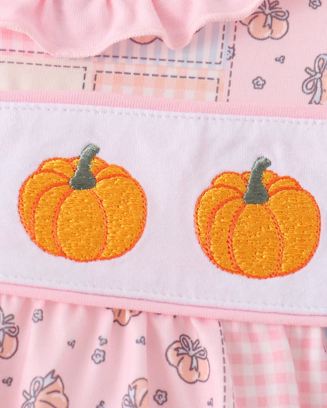 Pink-and-white bubble romper with two orange pumpkin appliques and gray stems