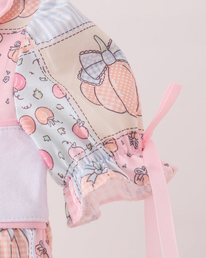 Pink-and-blue printed bubble romper with long puff sleeves and ribbon ties